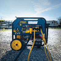 A FIRMAN Power Equipment Tri Fuel 8000W Portable Generator Electric Start 120/240V with CO ALERT sits on gravel, powering multiple devices. Multiple cables are attached, with an RV and a fence visible in the background.