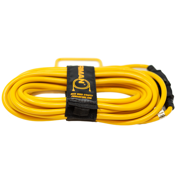 A coiled yellow FIRMAN Power Equipment 25' Heavy Duty 5-15P to 5-15R Generator Utility Power Cord with a black storage strap and a branded label.