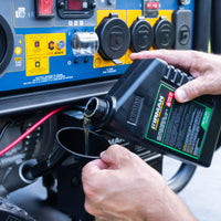 Close-up of hands pouring oil from a bottle into a FIRMAN Power Equipment Tri Fuel Portable Generator 11600W Electric Start 120V/240V with CO alert's engine, with visible control labels and buttons.