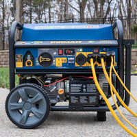A FIRMAN Power Equipment Tri Fuel Portable Generator 11600W Electric Start 120V/240V with CO alert on a driveway, featuring large wheels, control panel with various outlets, and a connected yellow power cord.