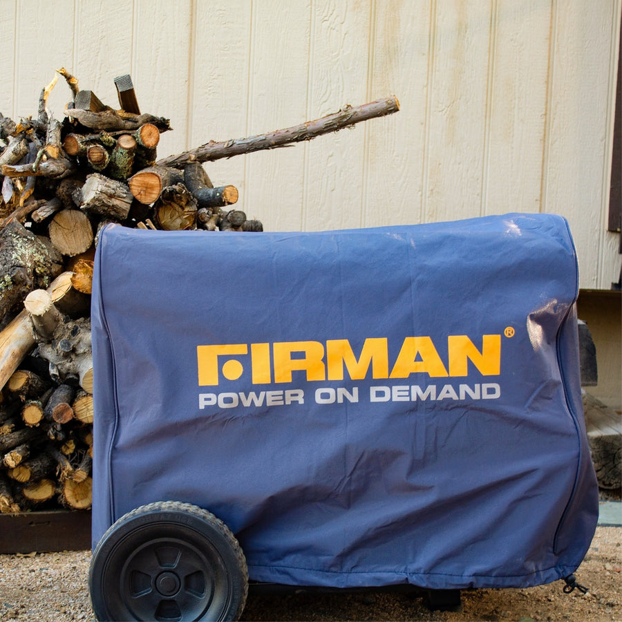 A FIRMAN Power Equipment Large Size Portable Generator Cover, in blue, protects a portable generator placed on the ground next to firewood and against a beige wall.