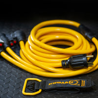 The FIRMAN Power Equipment 25' Heavy Duty TT-30P to (3)5-20R generator power cord features a black plug, yellow cable, and storage strap, all coiled neatly on a textured black surface.