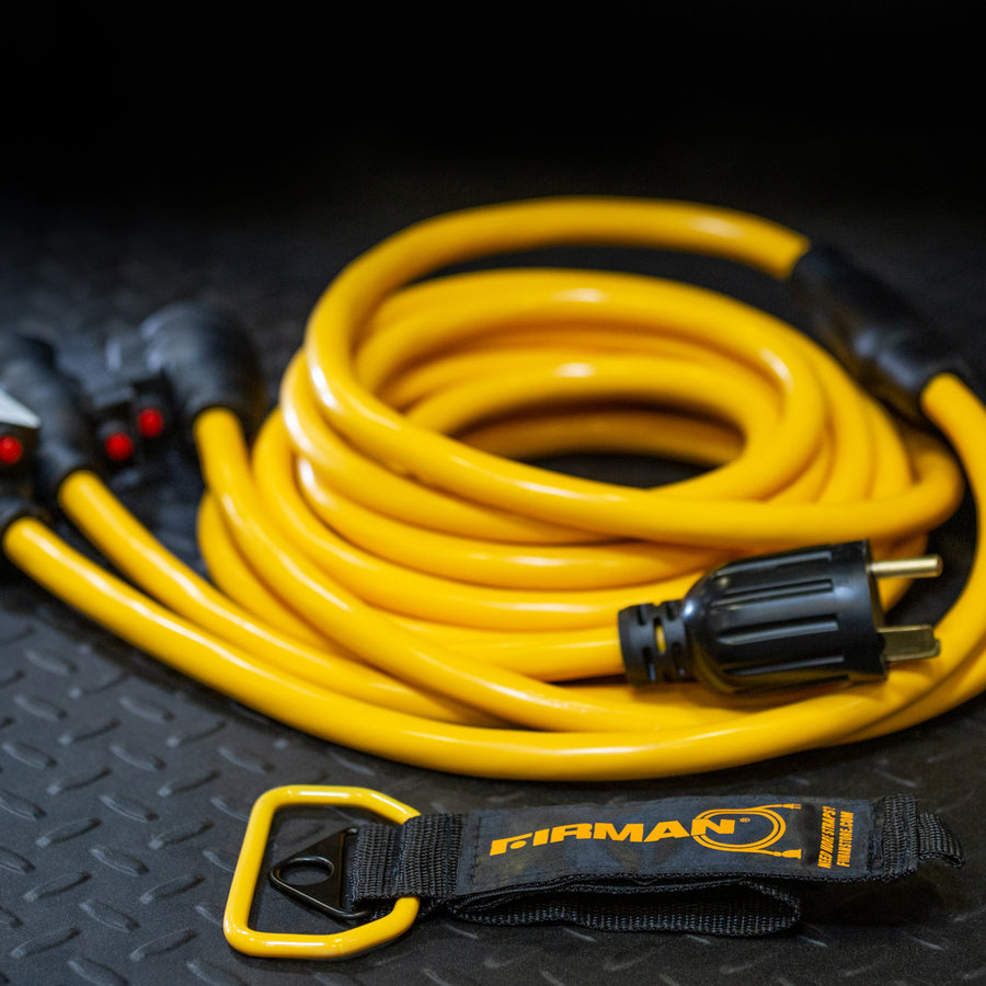 The FIRMAN Power Equipment 25' Heavy Duty TT-30P to (3)5-20R generator power cord features a black plug, yellow cable, and storage strap, all coiled neatly on a textured black surface.