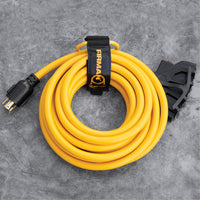 The FIRMAN Power Equipment 25ft Heavy Duty L14-30P to (4) 5-20R Power Cord with storage strap rests on a gray stone surface—ideal for reliable generator power connections.