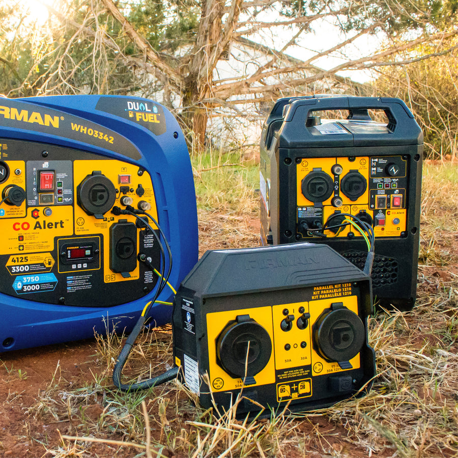 Three RV ready inverter generators with yellow control panels are connected outdoors using FIRMAN Power Equipment’s 50A PORTABLE GENERATOR PARALLEL KIT, positioned near trees and dry grass.
