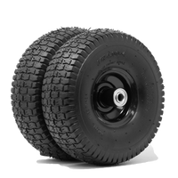 Two stacked black all-terrain go-kart tires with visible treads, mounted on dark metal rims, isolated on a white background from FIRMAN Power Equipment's 11' Wheel Kit and Handle.