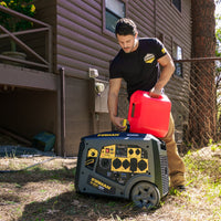 A person is refueling a FIRMAN Power Equipment Gas Inverter Portable Generator 6650/5300 Watt 120/240V CO Alert using a red gasoline container beside a brown wooden building.