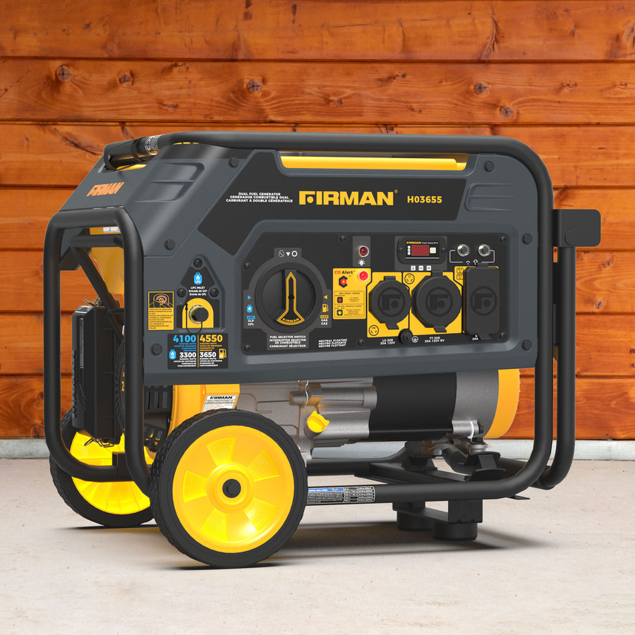 A FIRMAN Power Equipment Dual Fuel Portable Generator 4550/3650W Recoil Start with control panel, wheels, and handle sits on a concrete floor by a wooden wall, providing dependable energy wherever needed.