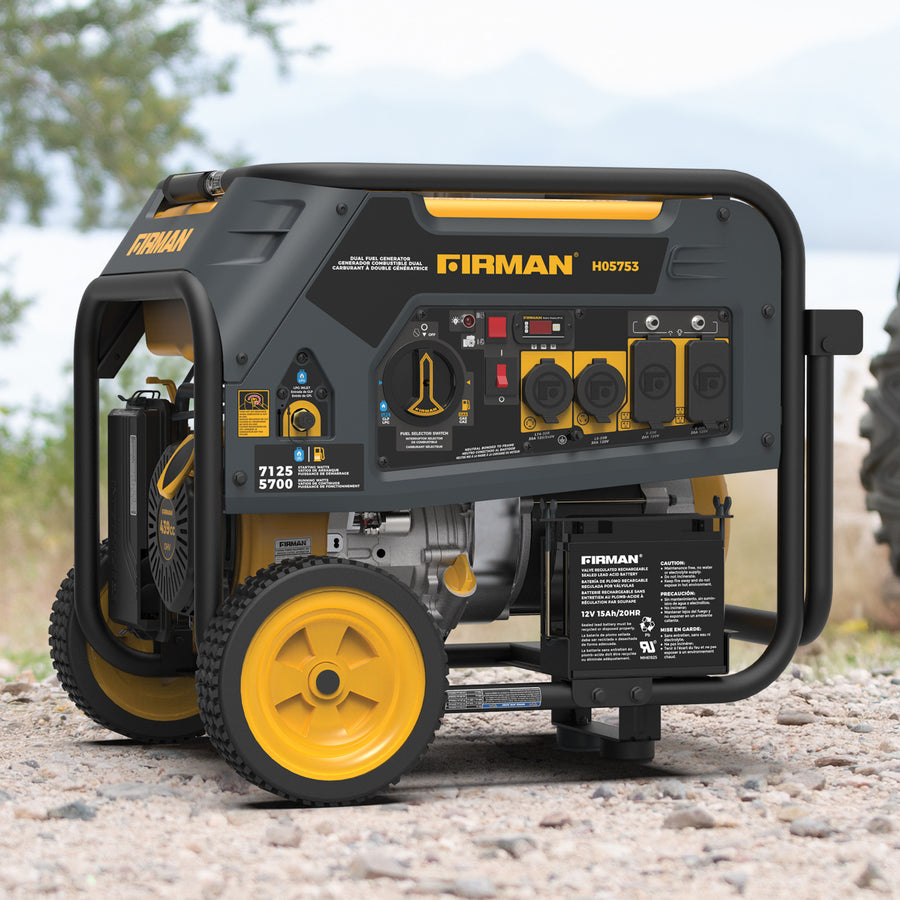 The FIRMAN Power Equipment Dual Fuel Portable Generator 5700W Electric Start 120/240V, in green and yellow, offers reliable backup power on gravel, with multiple outlets and labeled controls shown against a blurred backdrop of trees and a lake, highlighting its suitability for versatile outdoor use.