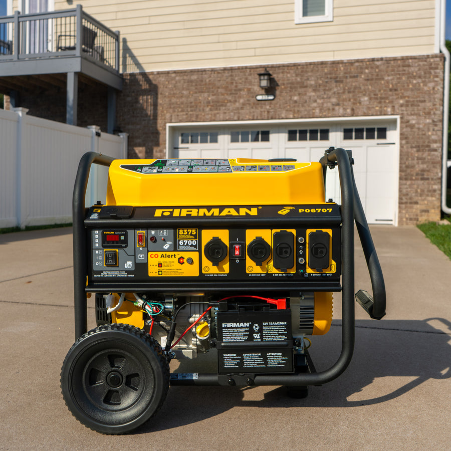 A yellow FIRMAN Power Equipment GAS PORTABLE GENERATOR 8375W REMOTE START 120/240V with wheels is on a concrete driveway in front of a closed garage door and a house.