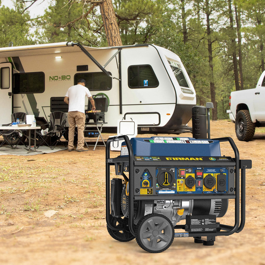 A FIRMAN Power Equipment Tri Fuel Portable Generator 7850/6300W Electric Start Gas CO Alert sits on the ground in front of an RV at a campsite, while a person stands by a table under the RV awning.