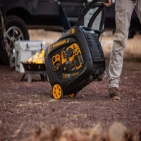 A person pulls a FIRMAN Power Equipment Refurbished Inverter Portable Generator 3300W Remote Start with yellow wheels outdoors, with a fire pit, cooler, and vehicle in the background.