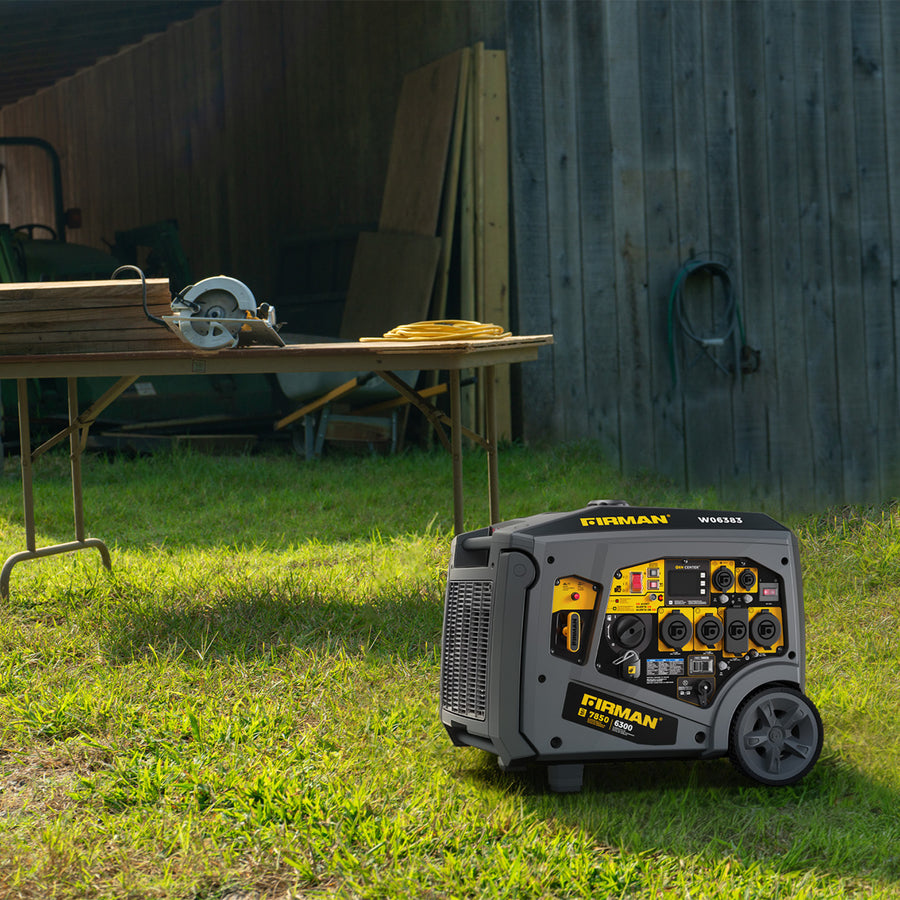 A quiet FIRMAN Power Equipment Gas Inverter Portable Generator 7850/6300 Watt Remote Start sits on grass near a table with a circular saw, extension cord, and stacked wood by a wooden fence and shed.