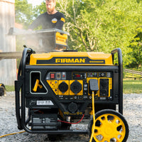 A FIRMAN Power Equipment Dual Fuel Open Frame Inverter 4500W Electric Start with CO Alert is running outdoors on gravel, while a person uses power tools in the background.