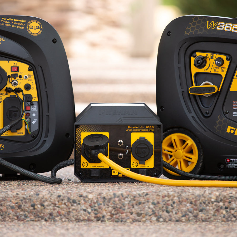 Two FIRMAN Power Equipment generators linked on a pebble surface using a 30A Portable Generator Parallel Kit.