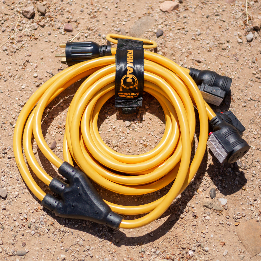A yellow FIRMAN Power Equipment 25' Heavy Duty TT-30P to (3)5-20R Portable Generator Power Cord With Storage Strap on the ground.