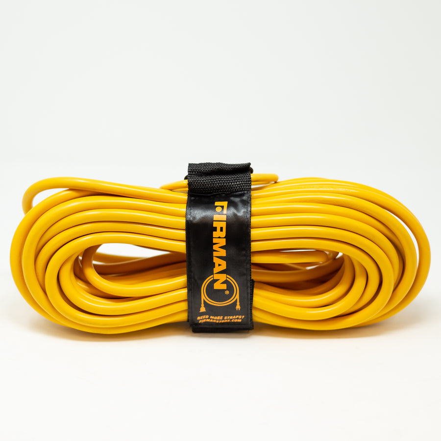 Coiled yellow FIRMAN Power Equipment generator utility power cord secured with a black velcro storage strap labeled "firman" against a white background.