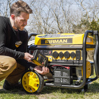 Man kneeling beside a yellow and black FIRMAN Power Equipment Gas Portable Generator 11400W Remote Start 120/240V with CO alert outdoors, reading the instruction manual.