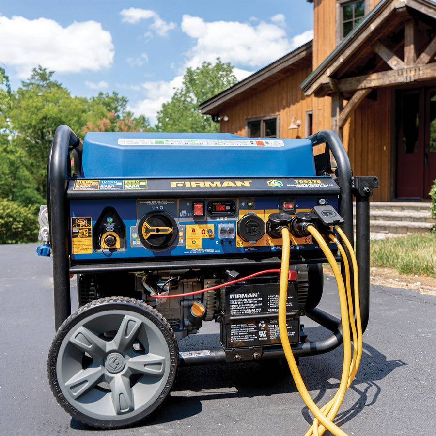 Lifestyle Image: Generator Model T09275 connect to multiple power cords outside on a driveway.