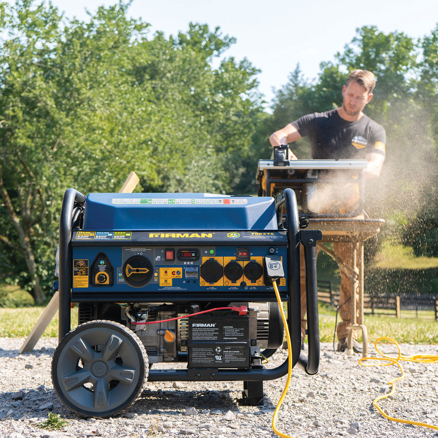 Lifestyle Image: Generator Model T09275 connect to a power cord that is providing energy to a man using an electric saw in an outdoor environment.