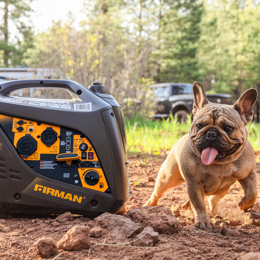 A French bulldog standing next to a FIRMAN Power Equipment Refurbished Gas Inverter 2000W Recoil Start portable generator in a forested area, with a vehicle in the background.