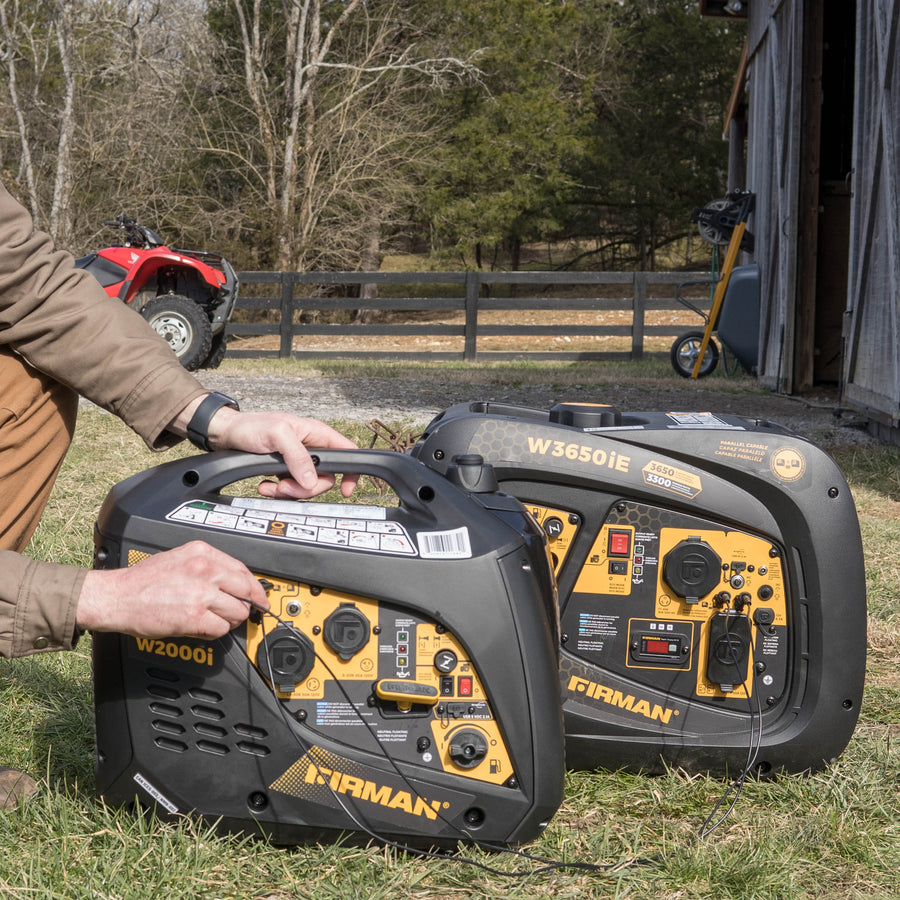 Man setting up two refurbished FIRMAN Power Equipment Gas Inverter 2000W Recoil Start generators outdoors near a barn, with a red ATV and a scooter visible in the background.