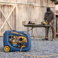 A man in a beanie works at a table saw near a blue FIRMAN Power Equipment Dual Fuel Inverter Portable Generator 3200W Electric Start outside a wooden barn.