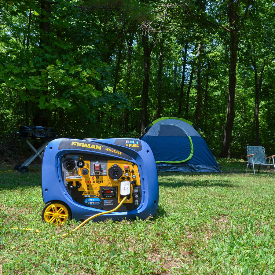 Portable generator from the FIRMAN Power Equipment Whisper Hybrid Series in a grassy campsite with a tent and camping chair in the background, surrounded by trees.