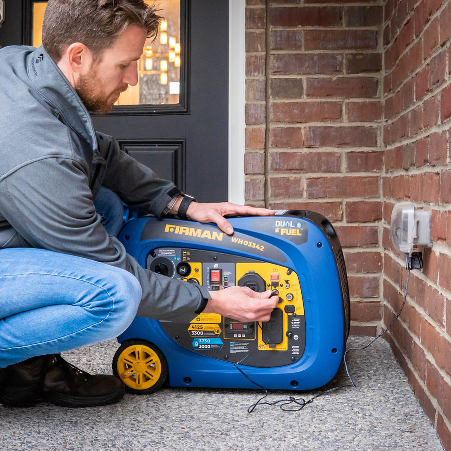A man connects a FIRMAN Power Equipment Dual Fuel Inverter Portable Generator 4125W Electric Start with CO ALERT outside a brick house.